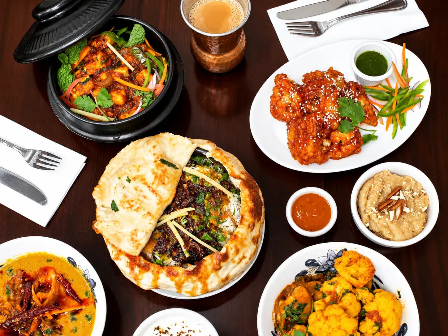 A generous table of Indian dishes ready to share
